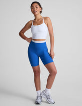 blue high-waisted biker shorts with a 5" inseam, waistband colorblock panels, and
contrast piping detail on leg.